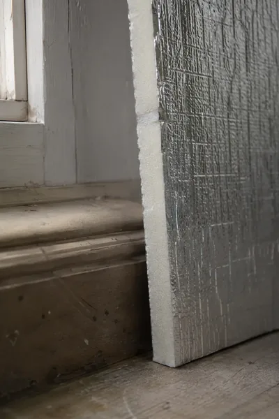 Dry lining insulation board at window reveal